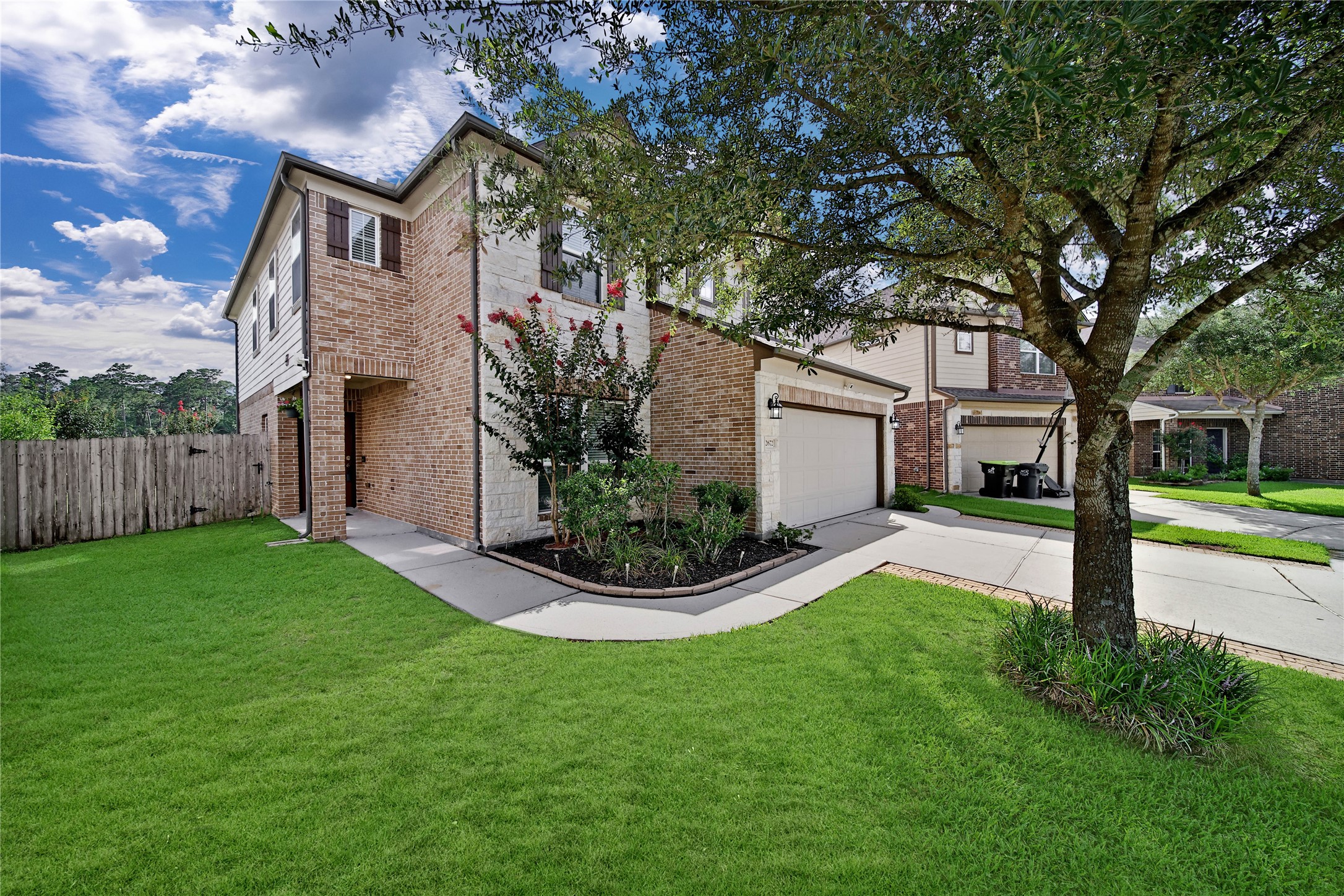 2672 Magnolia Fair Way Spring, TX 77386 - Photo 4 of 49 A manicured front lawn and spacious covered porch with a smart doorbell and keypad door lock welcome you home.