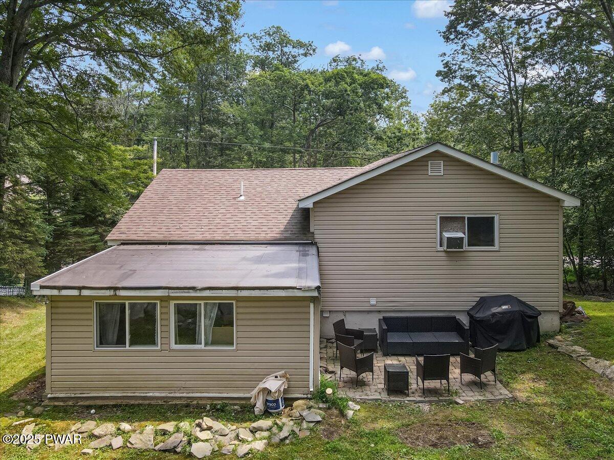 192 Heather Hill Road Dingmans Ferry, PA 18328 - Photo 48 of 74 a backyard of a house with table and chairs