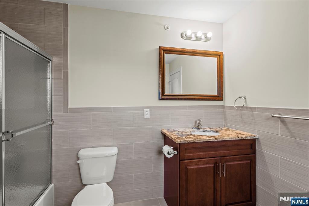 731 Stuyvesant Avenue, Unit 2 Lyndhurst, NJ 07071 - Photo 18 of 24 a bathroom with a toilet sink and mirror