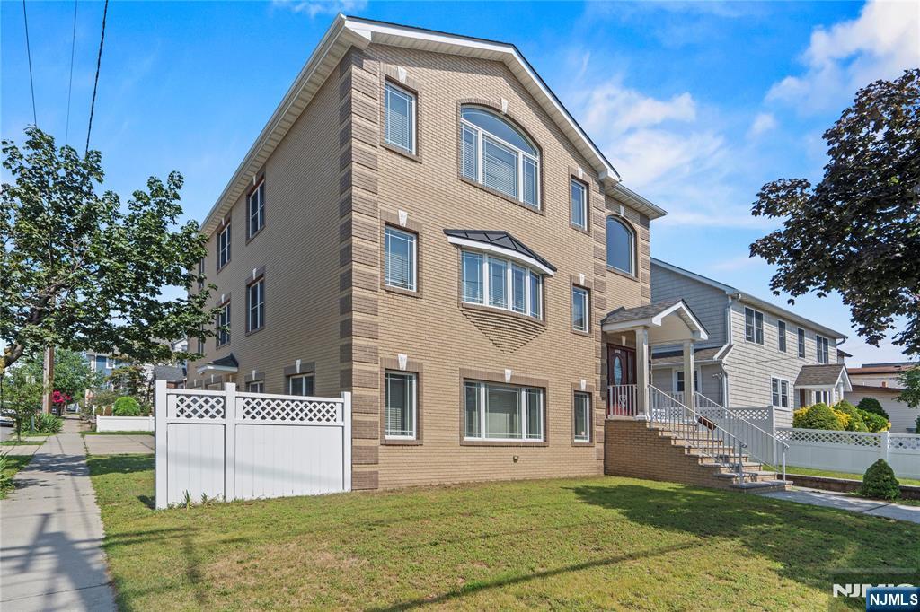 731 Stuyvesant Avenue, Unit 2 Lyndhurst, NJ 07071 - Photo 2 of 24 a front view of a house with a garden