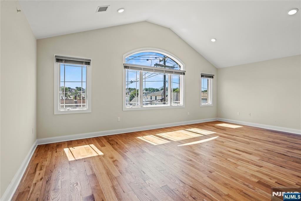 731 Stuyvesant Avenue, Unit 2 Lyndhurst, NJ 07071 - Photo 9 of 24 wooden floor in an empty room with a window