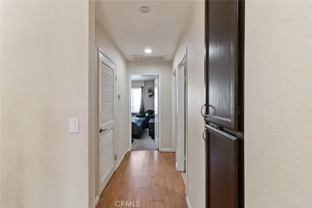 a view of a hallway with a wooden floor