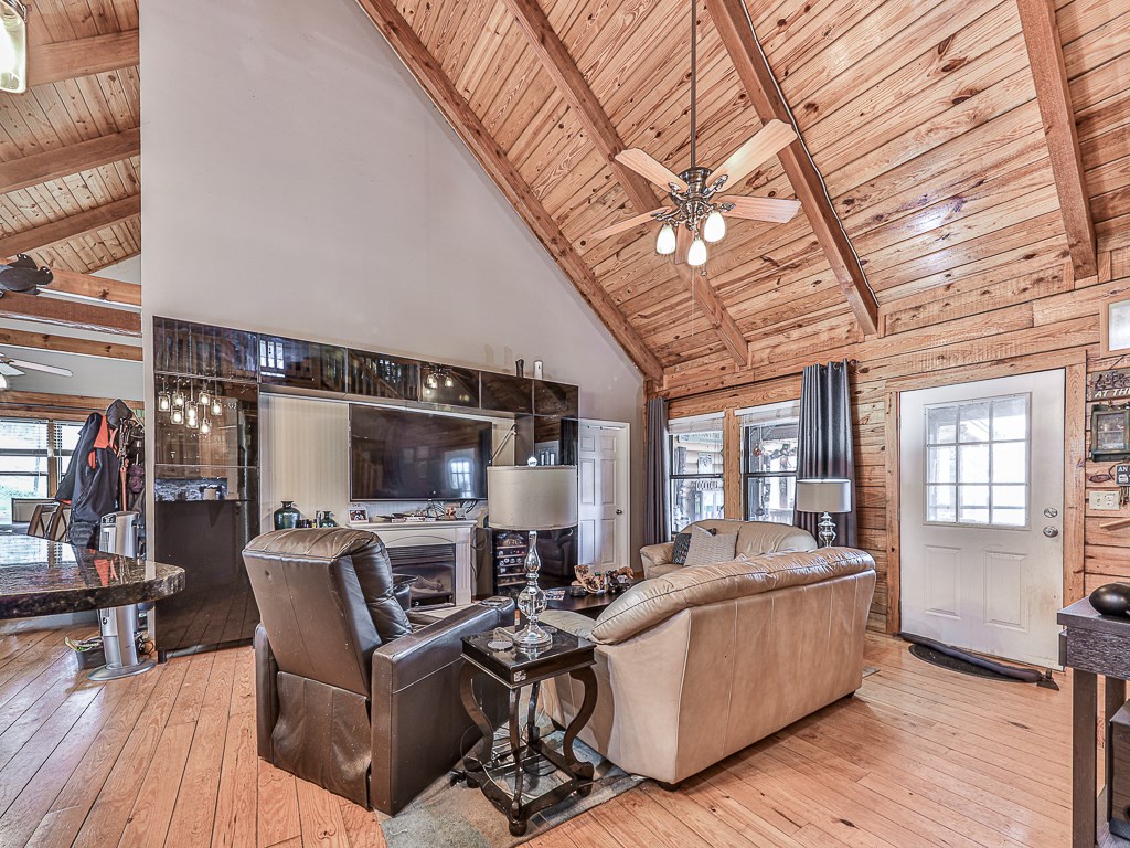 290 Ruby Lane Ellijay, GA 30540 - Photo 15 of 34 a living room with furniture a flat screen tv and a floor to ceiling window