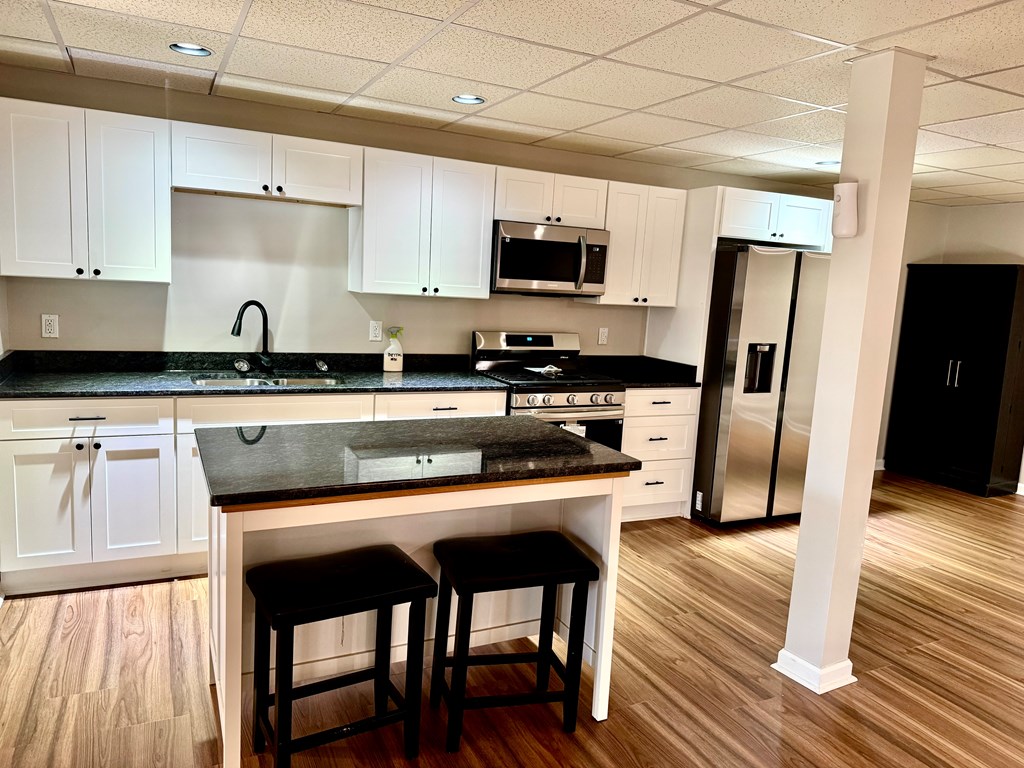290 Ruby Lane Ellijay, GA 30540 - Photo 16 of 34 a kitchen with stainless steel appliances granite countertop a table chairs microwave and sink