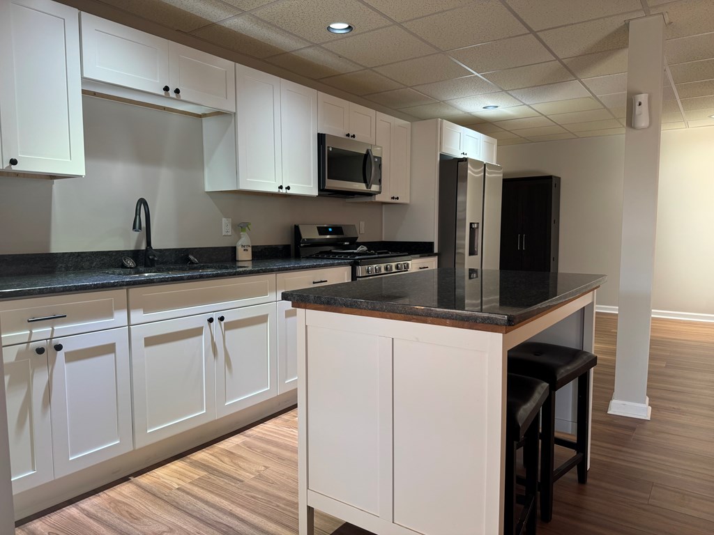 290 Ruby Lane Ellijay, GA 30540 - Photo 21 of 34 a kitchen with granite countertop white cabinets and stainless steel appliances