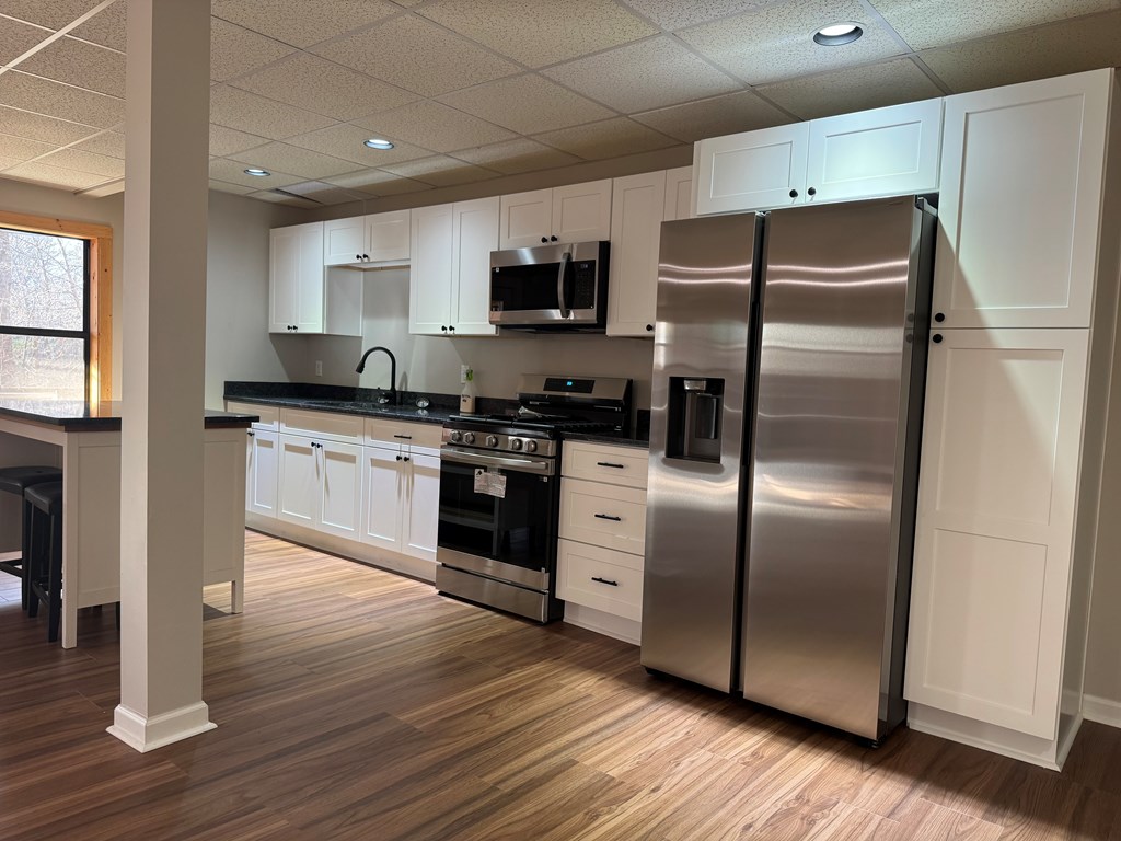 290 Ruby Lane Ellijay, GA 30540 - Photo 23 of 34 a kitchen with stainless steel appliances granite countertop a refrigerator a stove a sink and a microwave