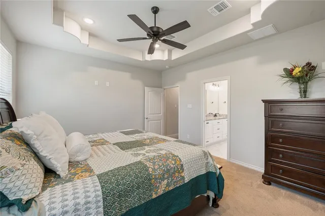 a bedroom with a bed and a ceiling fan