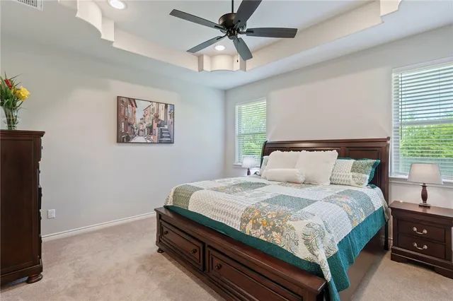 a bedroom with bed and a chandelier