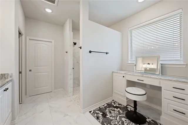 a bathroom with a granite countertop sink a toilet and shower