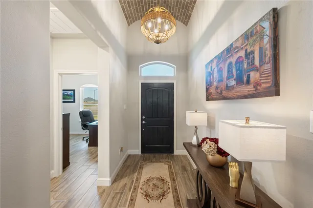 a dining room with furniture and a chandelier