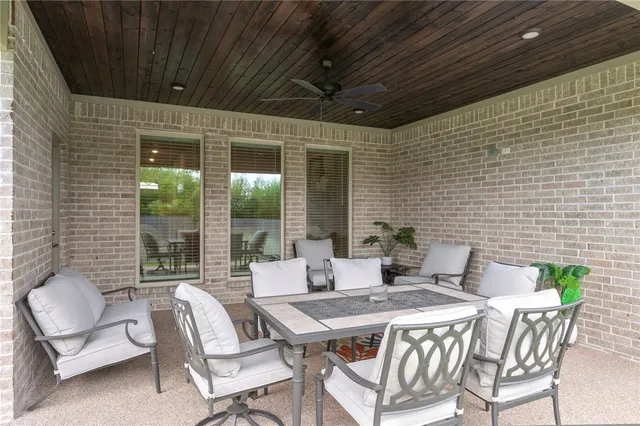 a patio with a table and chairs