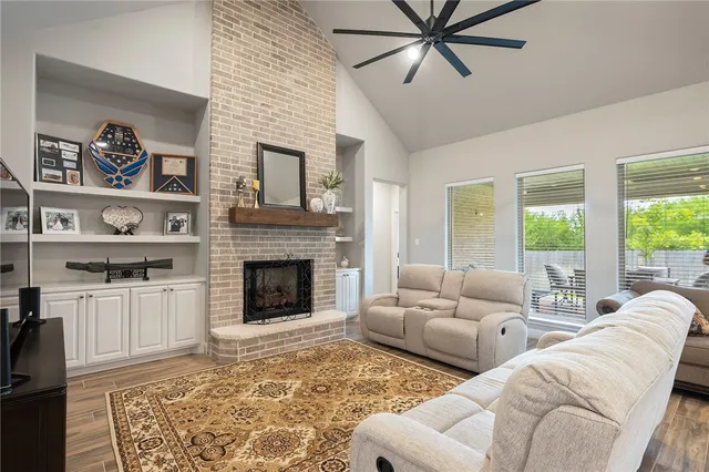 a living room with furniture and a fireplace