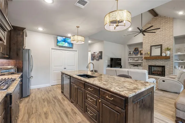 a kitchen with a stove and a wooden floor
