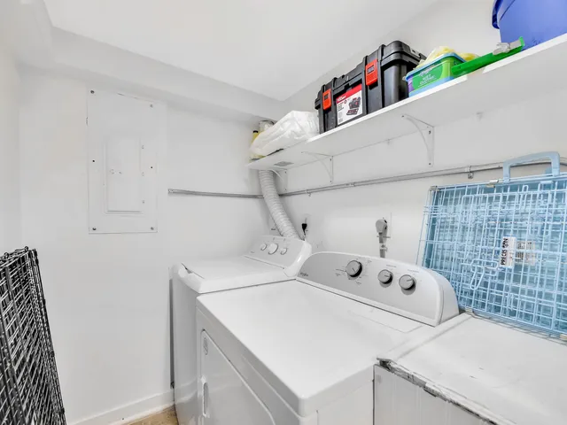a utility room with two washing machine