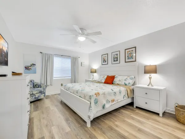 a spacious bedroom with a bed and a chandelier