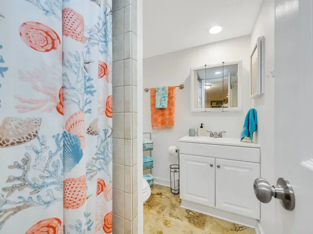 a bathroom with a sink a mirror and toilet