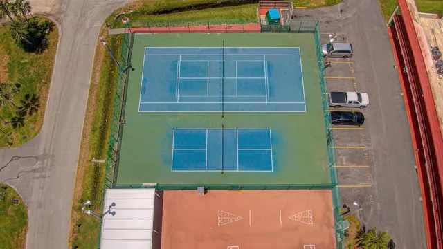 a group of people sitting in patio next to a yard