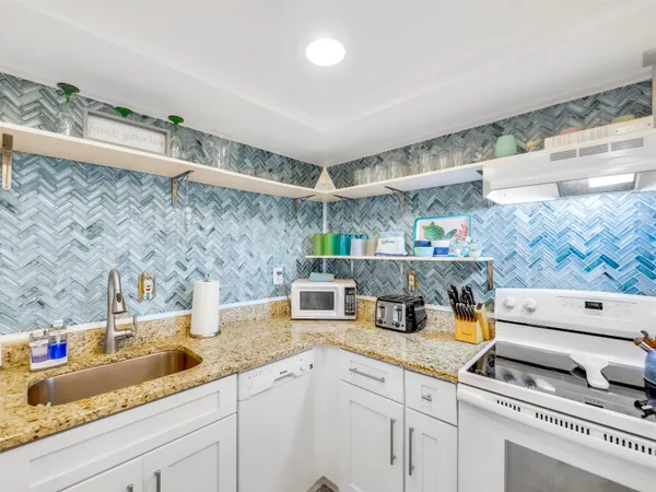 a kitchen with a sink stainless steel appliances and cabinets