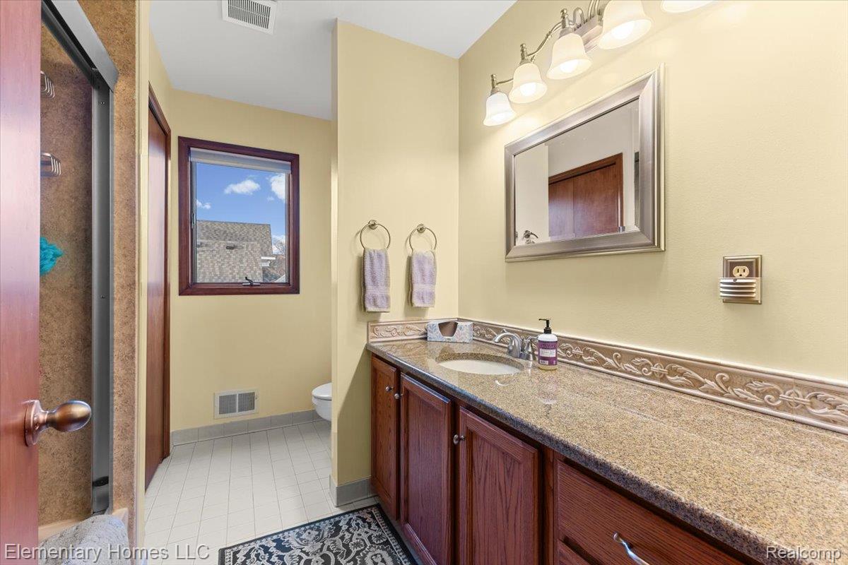 51637 Baker Road New Baltimore, MI 48047 - Photo 34 of 47 Bathroom featuring vanity, a stall shower, and light tile patterned flooring