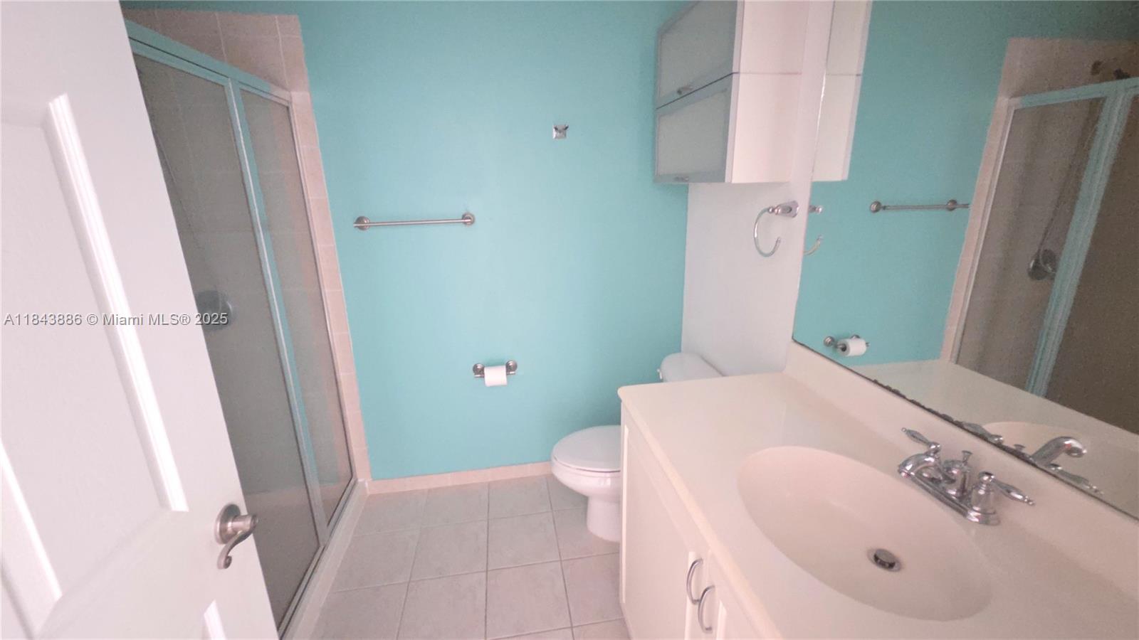 4605 Southwest 75th Way, Unit 4605 Davie, FL 33314 - Photo 31 of 42 a bathroom with a sink a toilet and shower curtain