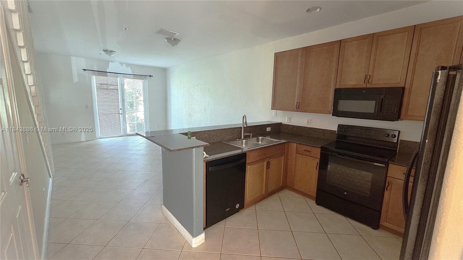 4605 Southwest 75th Way, Unit 4605 Davie, FL 33314 - Photo 5 of 42 a kitchen with a stove microwave and sink