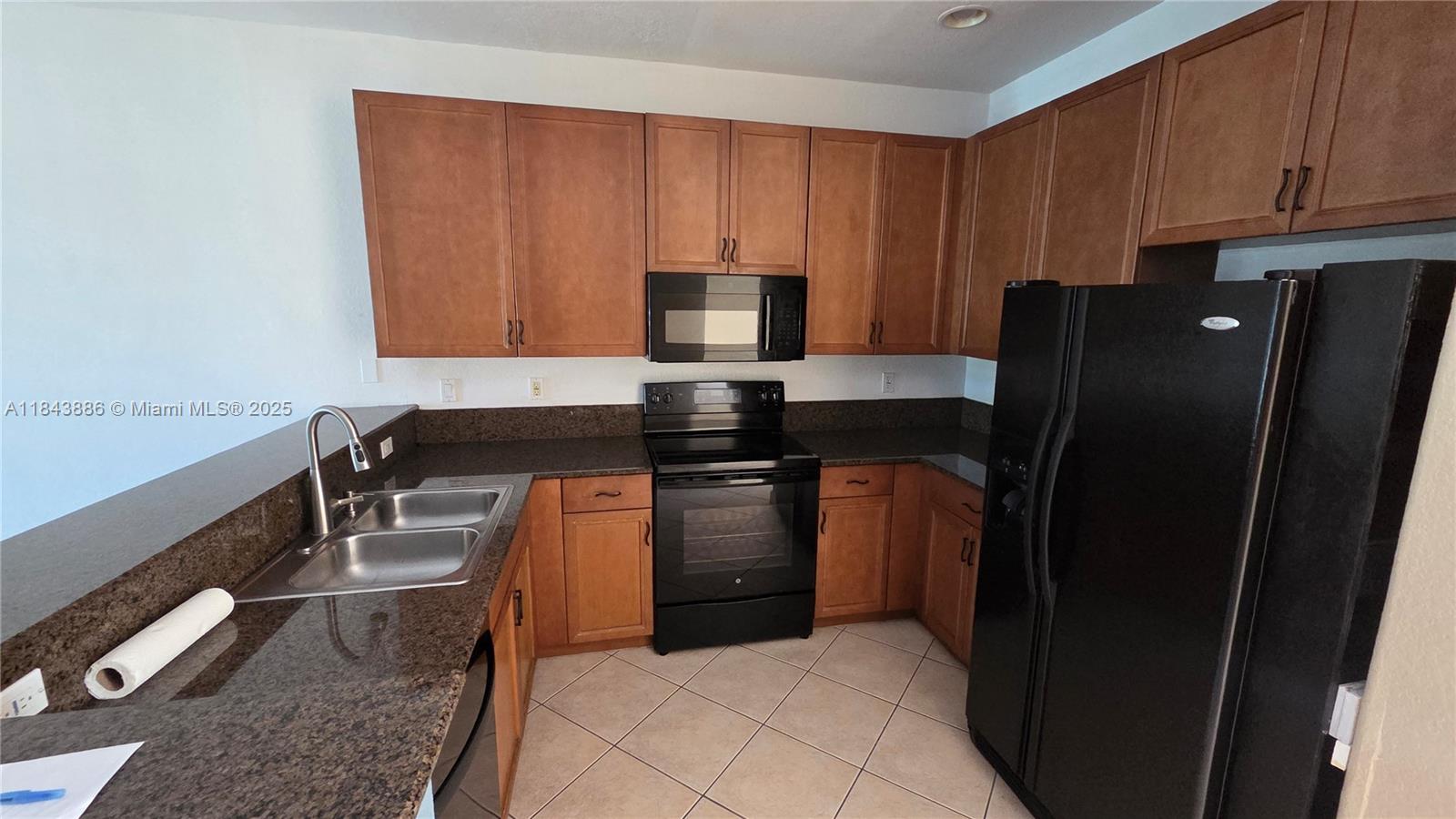 4605 Southwest 75th Way, Unit 4605 Davie, FL 33314 - Photo 7 of 42 a kitchen with stainless steel appliances granite countertop a refrigerator and a stove top oven