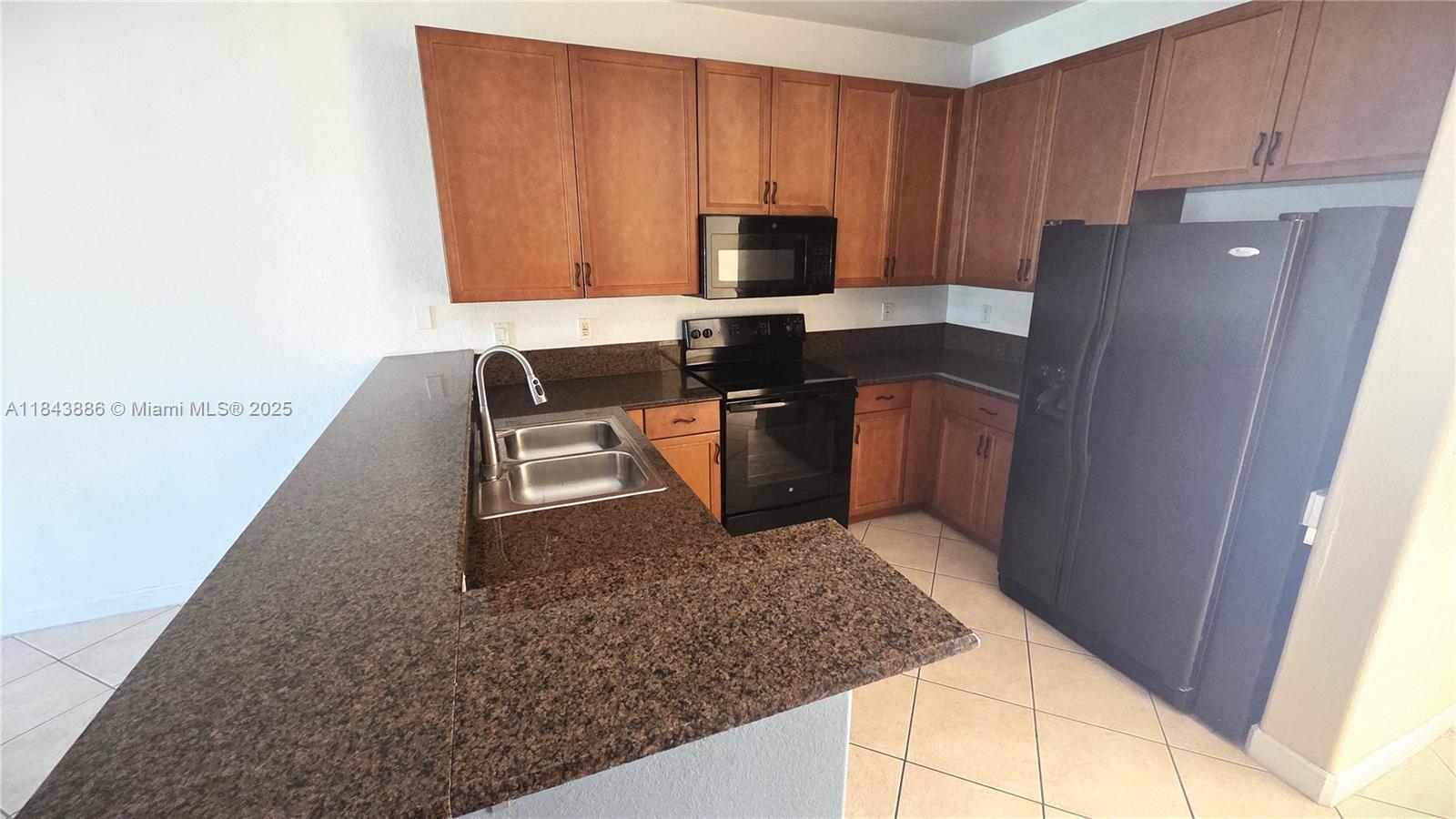 4605 Southwest 75th Way, Unit 4605 Davie, FL 33314 - Photo 9 of 42 a kitchen with stainless steel appliances granite countertop a sink stove and refrigerator