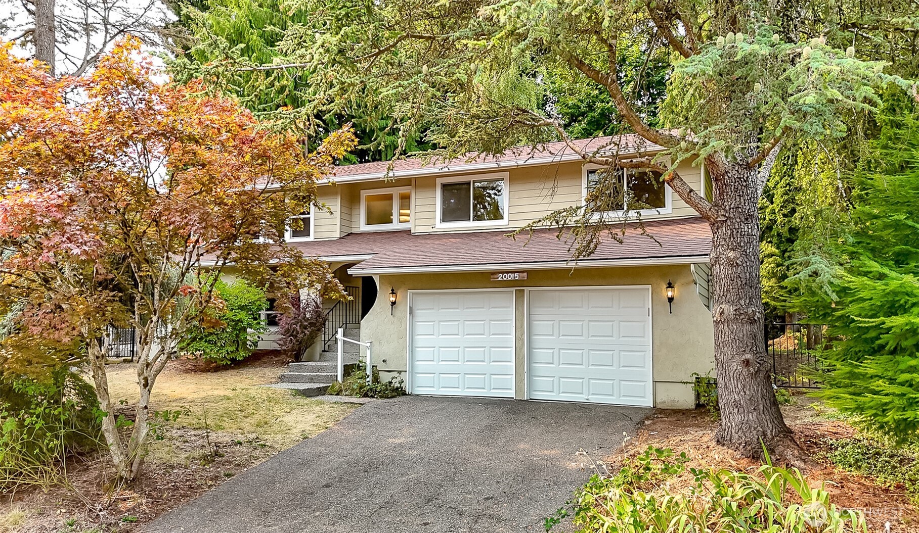 20015 108th Avenue Northeast Bothell, WA 98011 - Photo 1 of 28 a front view of a house with a yard and garage
