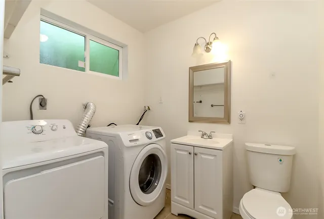 a bathroom with a sink and a washer dryer
