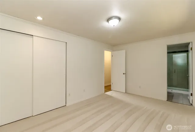 an empty room with windows and closet