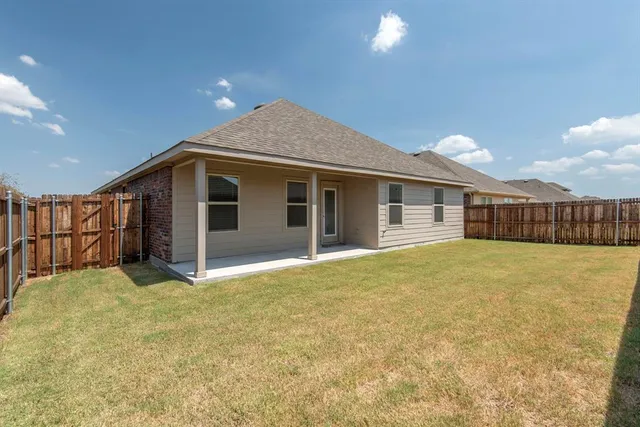 a view of a house with a yard and a garage