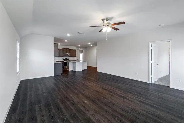 a view of a kitchen with a sink and a large window