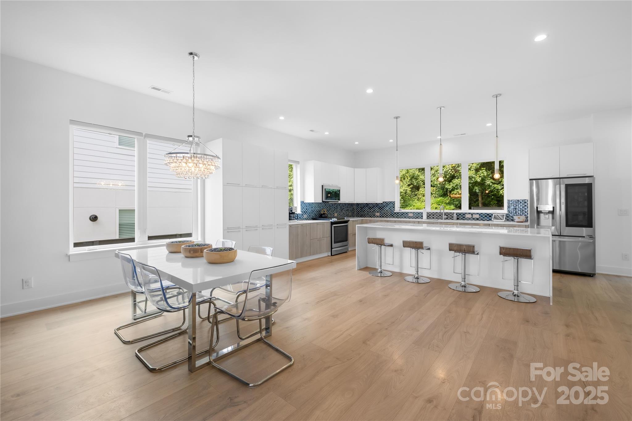 1627 Rama Road Charlotte, NC 28211 - Photo 15 of 43 a kitchen with stainless steel appliances kitchen island granite countertop a table chairs and a view of living room