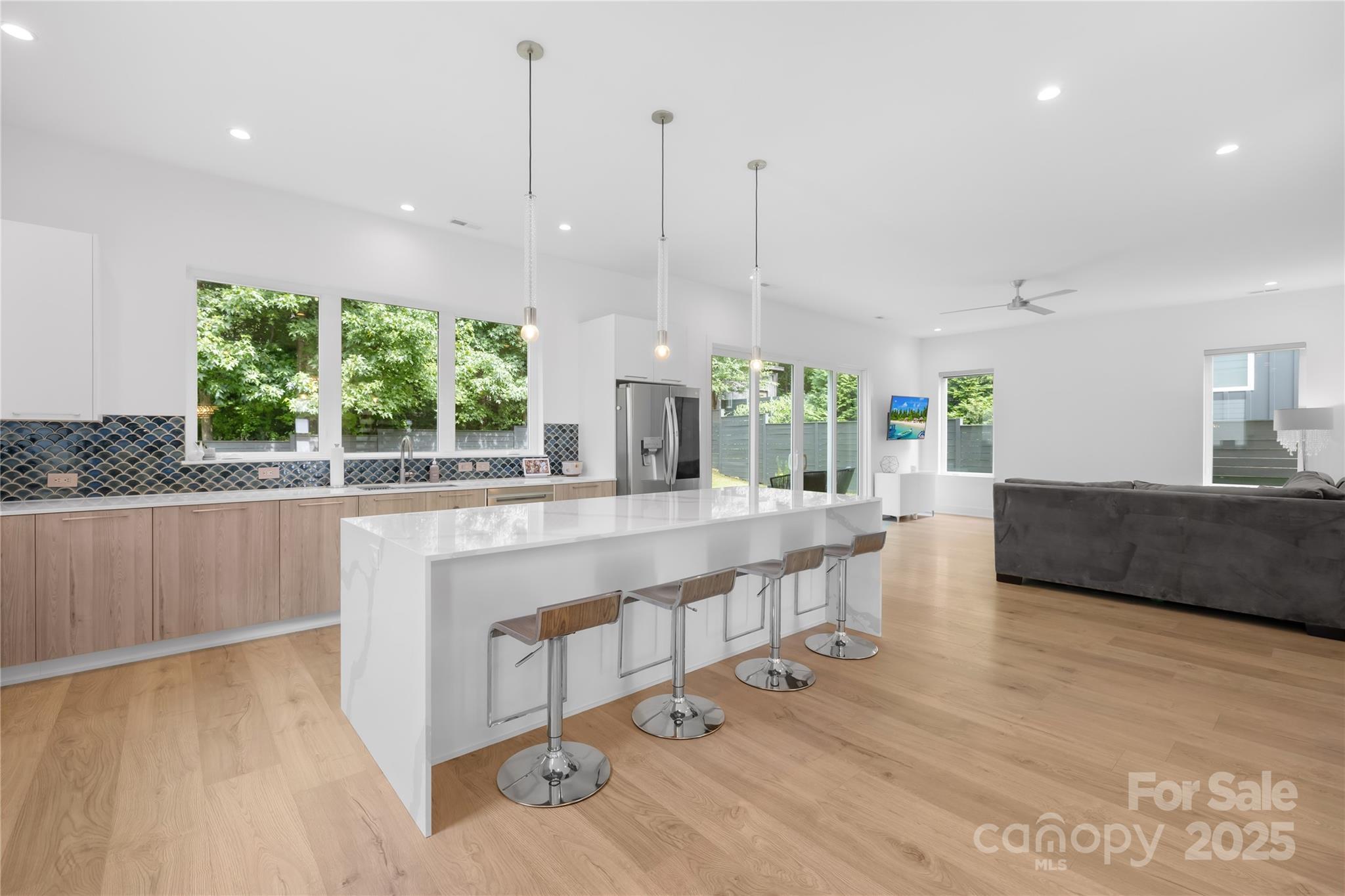 1627 Rama Road Charlotte, NC 28211 - Photo 17 of 43 a large kitchen with kitchen island a large counter top and a wooden floors
