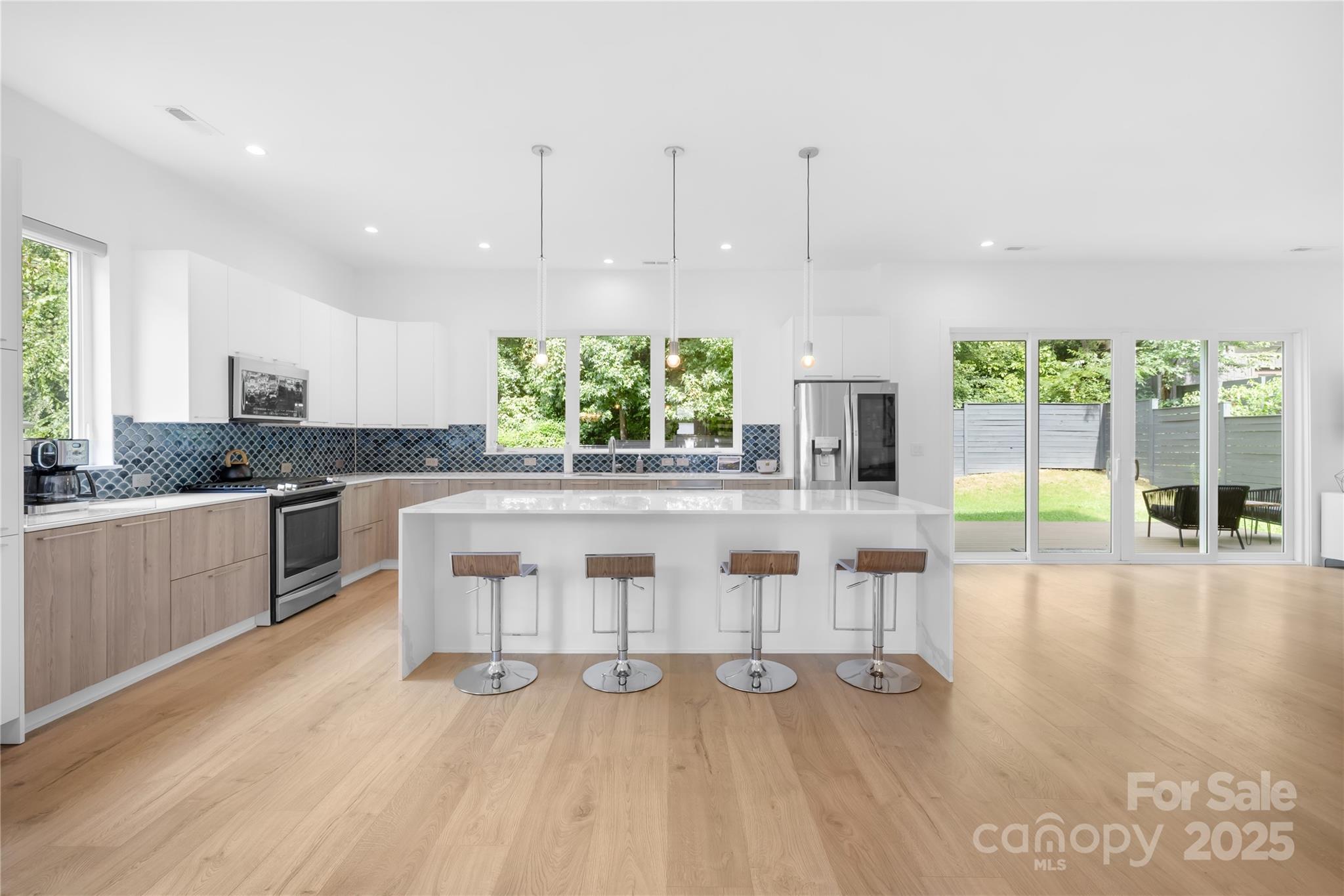 1627 Rama Road Charlotte, NC 28211 - Photo 19 of 43 a kitchen with stainless steel appliances granite countertop a lot of cabinets and wooden floor