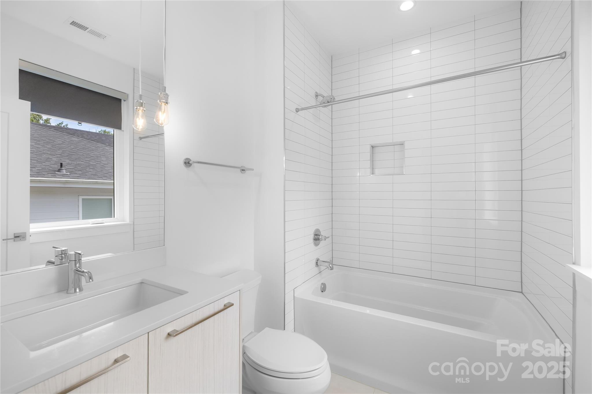 1627 Rama Road Charlotte, NC 28211 - Photo 32 of 43 a bathroom with a bathtub shower sink vanity and toilet