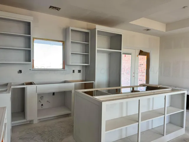 a kitchen with a stove and a refrigerator