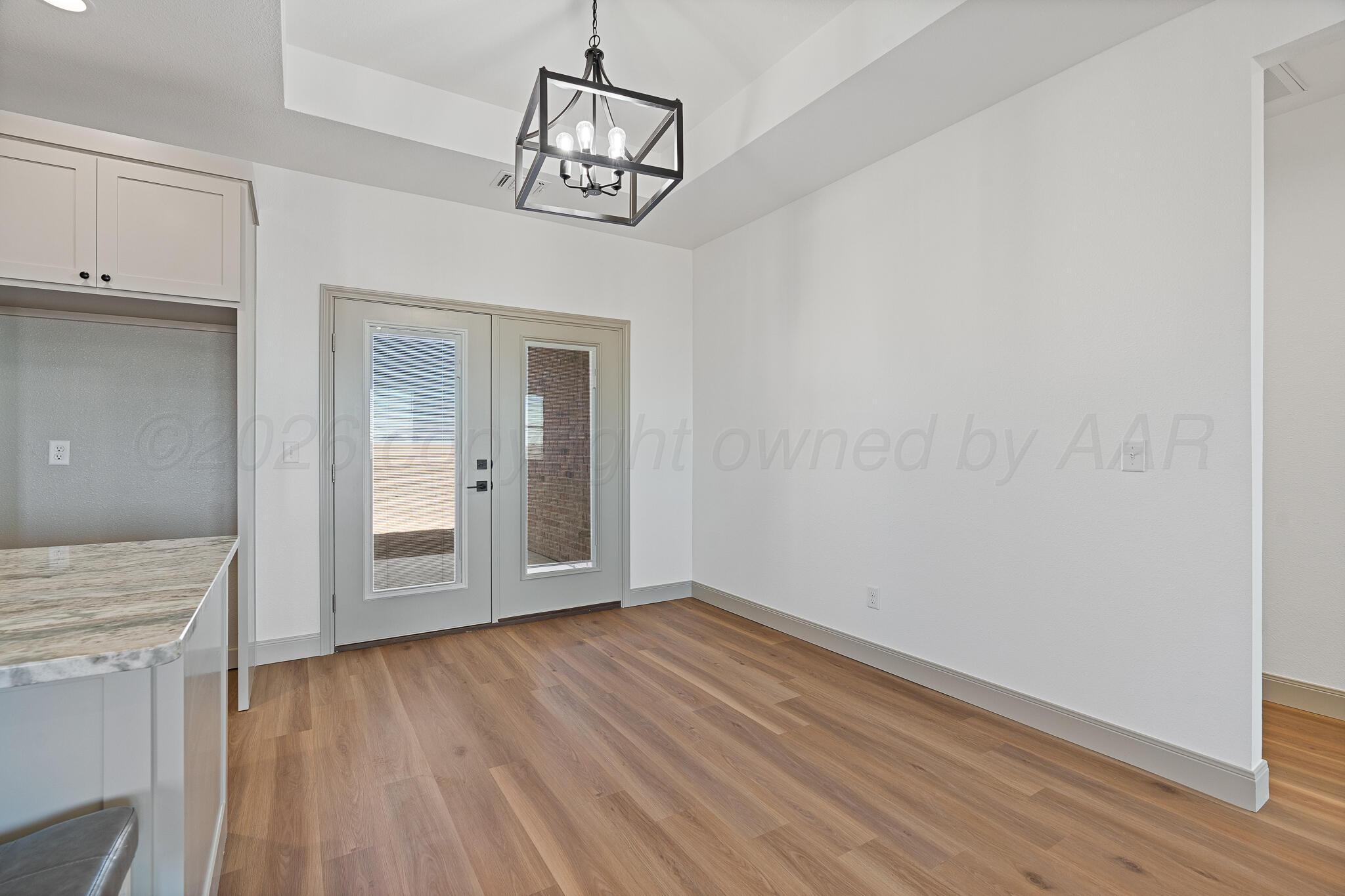 21700 Farm To Market Road 2219 Amarillo, TX 79119 - Photo 14 of 38 a view of empty room with wooden floor and fan
