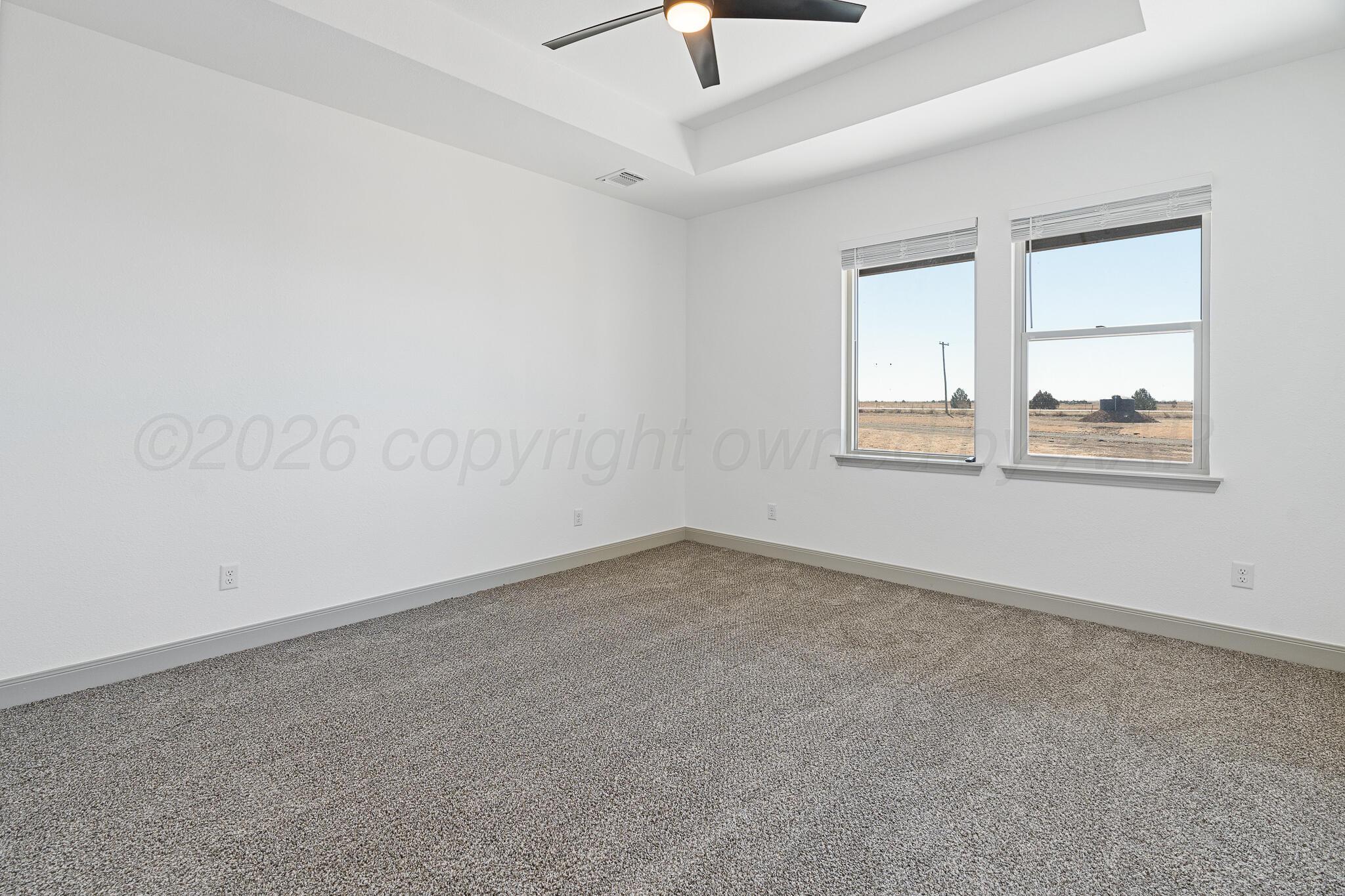 21700 Farm To Market Road 2219 Amarillo, TX 79119 - Photo 15 of 38 an empty room with a window and a ceiling fan