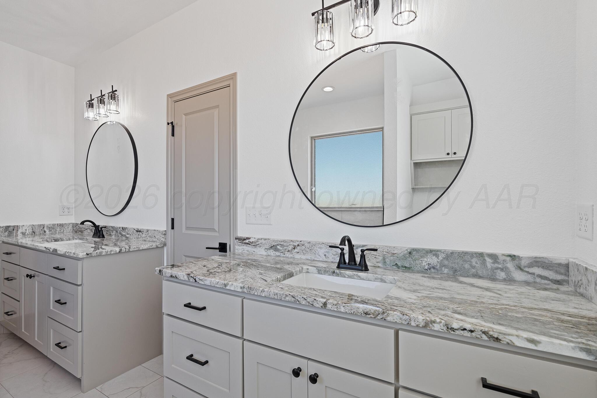 21700 Farm To Market Road 2219 Amarillo, TX 79119 - Photo 19 of 38 a bathroom with a granite countertop double vanity sink and a mirror