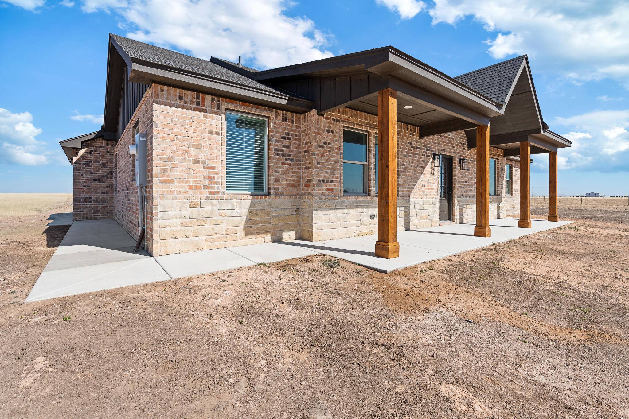 21700 Farm To Market Road 2219 Amarillo, TX 79119 - Photo 2 of 38 a front view of a house with a yard and garage