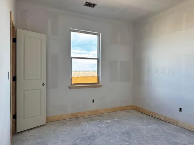 a view of an empty room with closet area