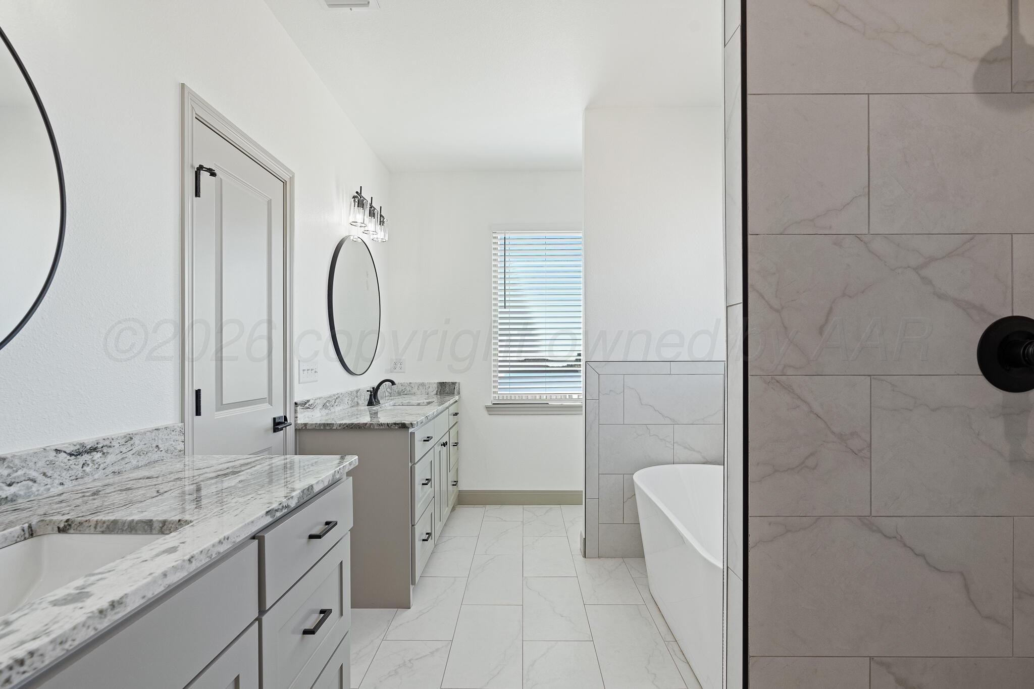 21700 Farm To Market Road 2219 Amarillo, TX 79119 - Photo 21 of 38 a bathroom with a granite countertop sink a toilet and a mirror