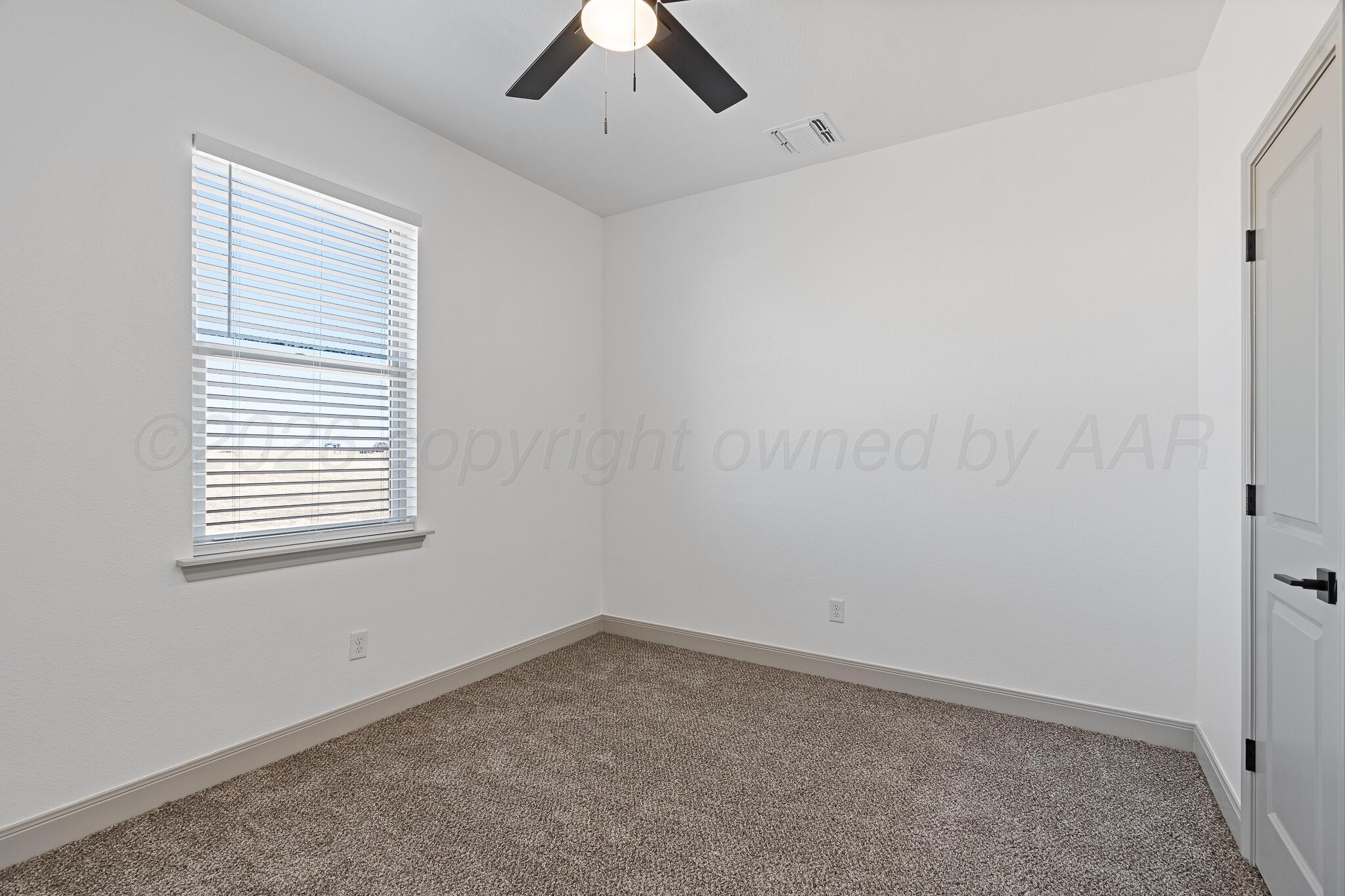 21700 Farm To Market Road 2219 Amarillo, TX 79119 - Photo 25 of 38 an empty room with a window and a ceiling fan