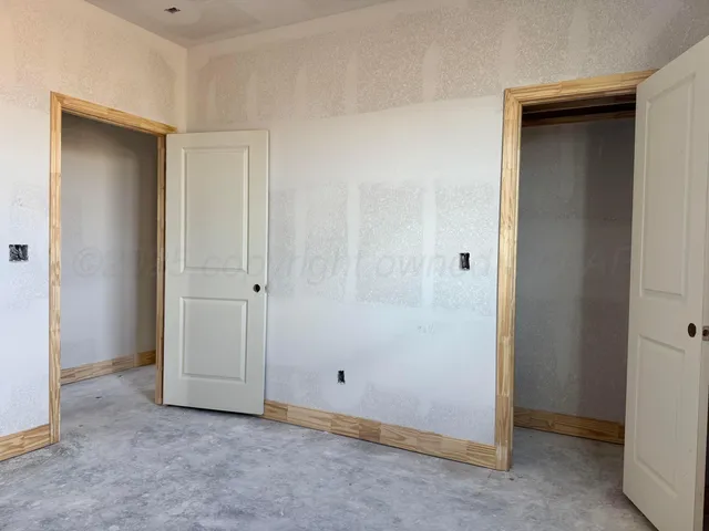 a view of a small space with wooden floor and a window