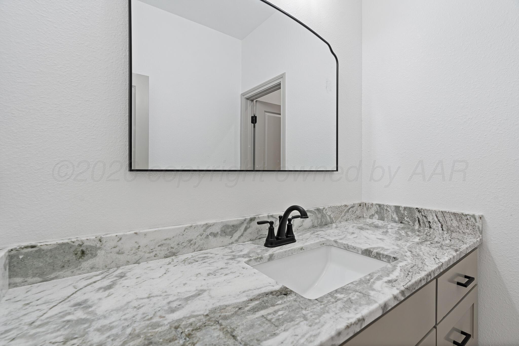 21700 Farm To Market Road 2219 Amarillo, TX 79119 - Photo 29 of 38 a bathroom with a granite countertop sink and a mirror