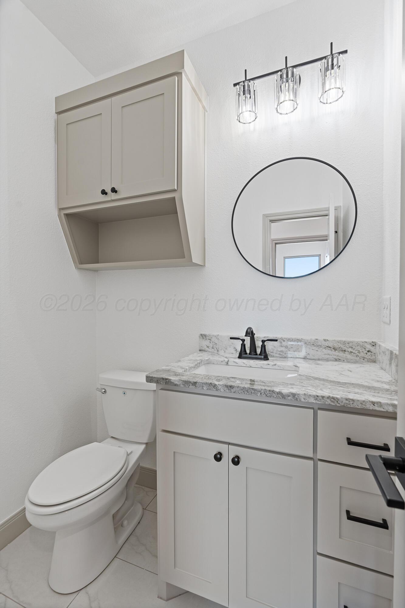 21700 Farm To Market Road 2219 Amarillo, TX 79119 - Photo 32 of 38 a bathroom with a granite countertop toilet sink and mirror