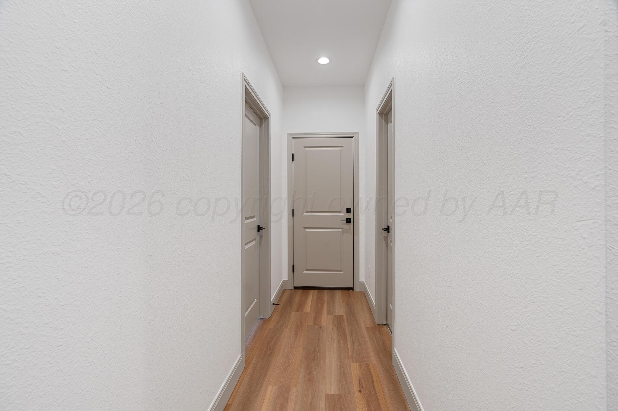 21700 Farm To Market Road 2219 Amarillo, TX 79119 - Photo 35 of 38 a view of a room with wooden floor and a hallway