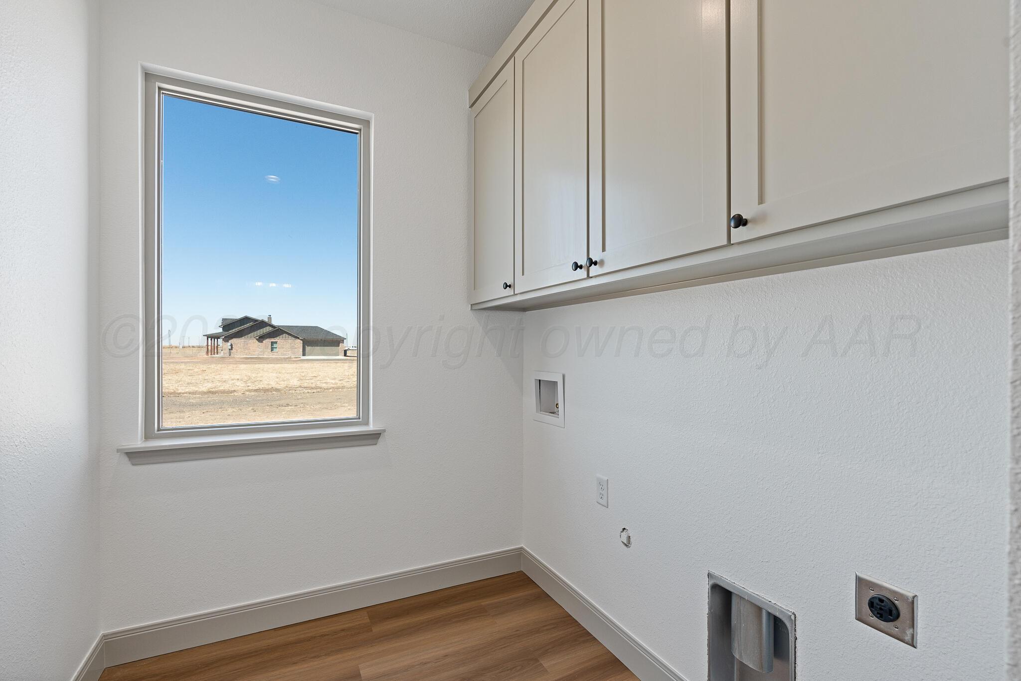 21700 Farm To Market Road 2219 Amarillo, TX 79119 - Photo 36 of 38 a view of an empty room with wooden floor and cabinets