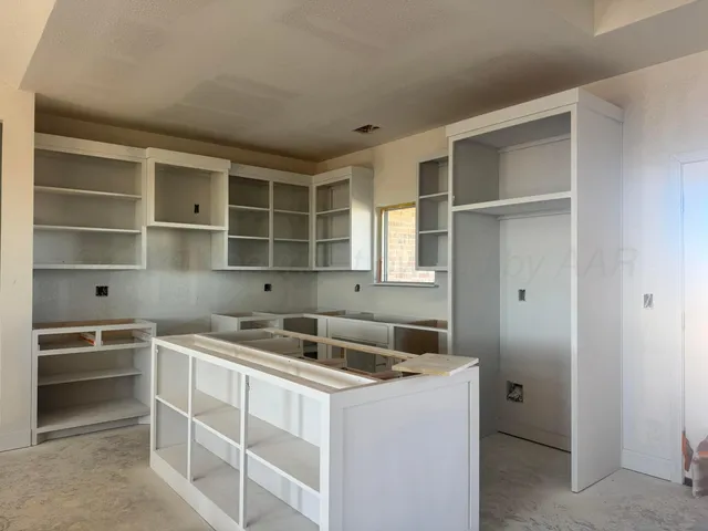 a kitchen with a sink and cabinets
